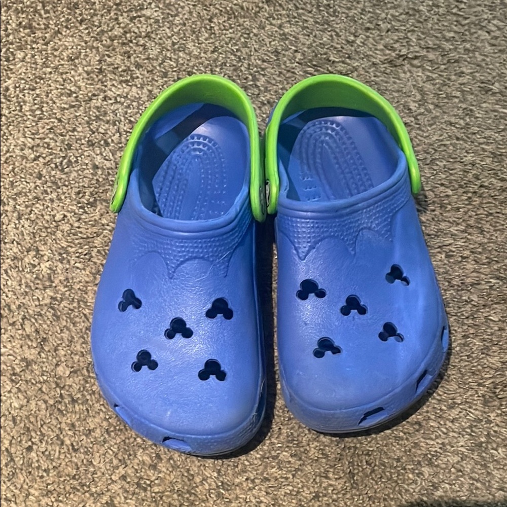 Crocs Disney Mickey Mouse clogs. Color is blue with green heel strap.